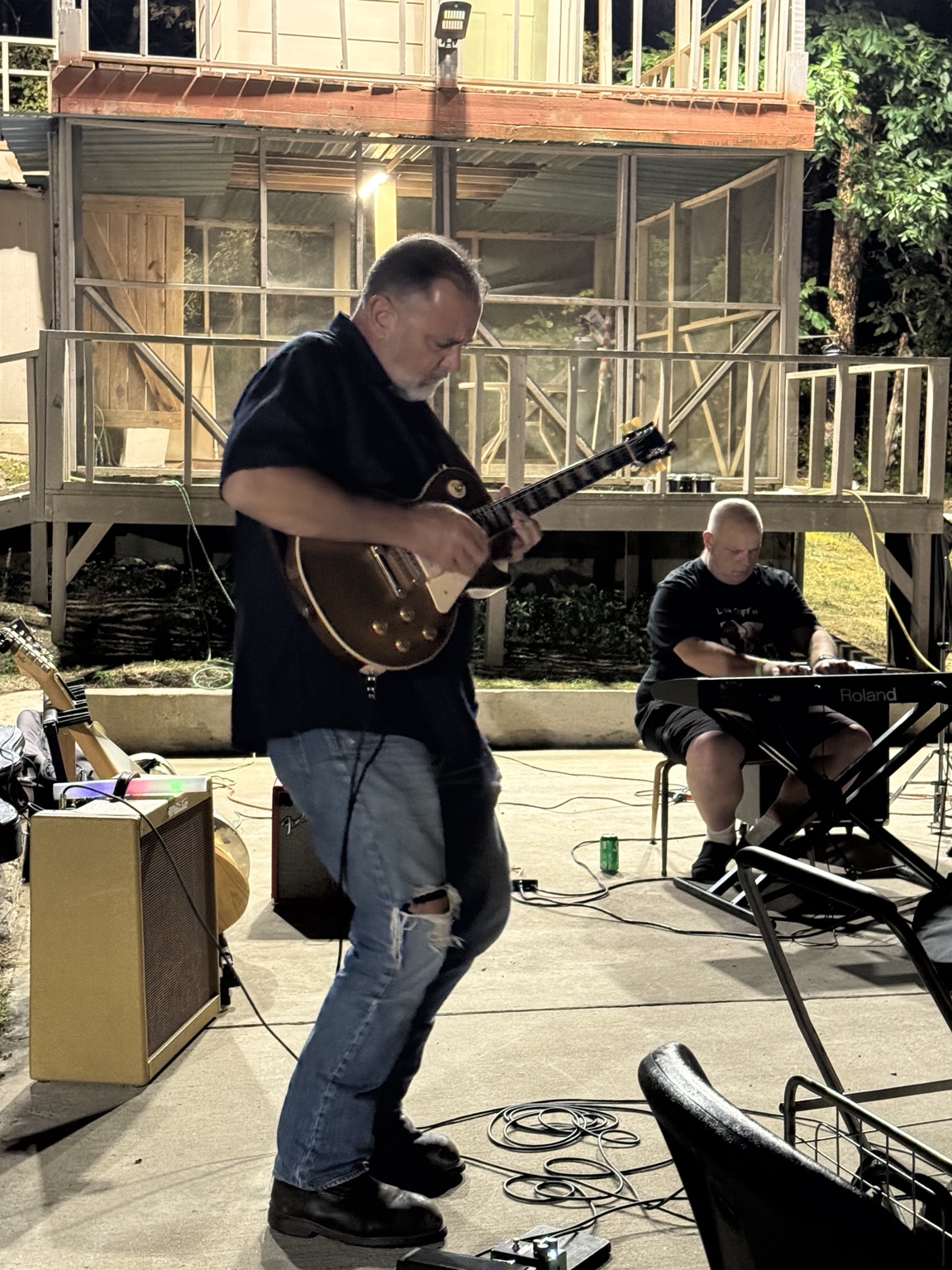 B. Douglas standing and playing guitar at the Burnside Blues Festival