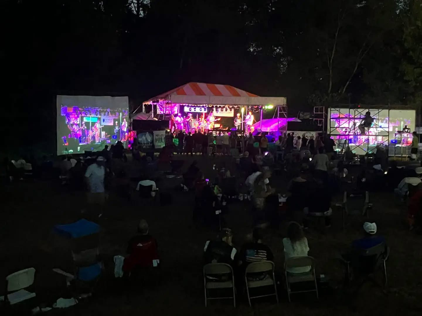 The large Goat Picnic outdoor stage framed by two 100-foot movie screens