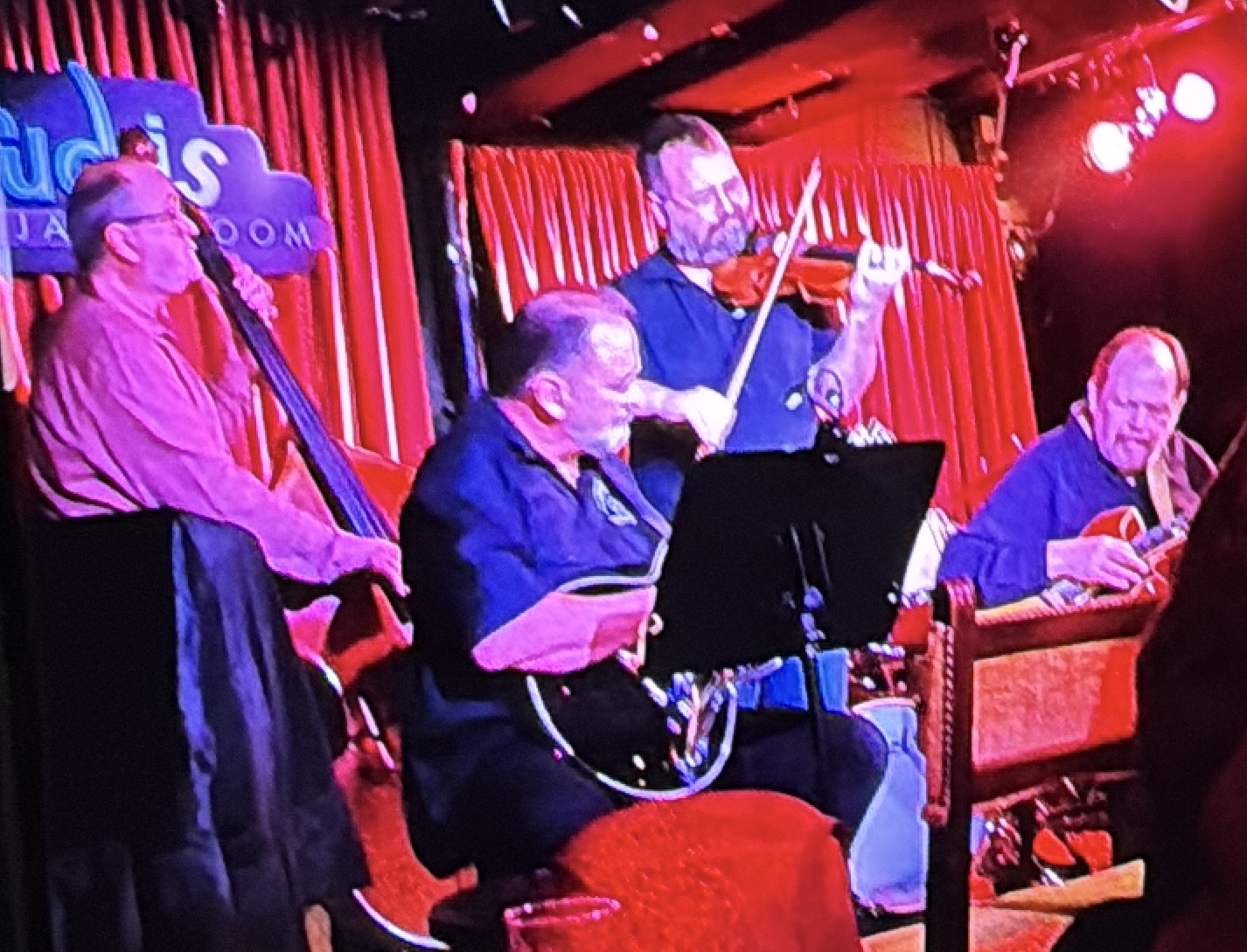 B. Douglas performing with fiddle and upright bass at Rudy’s Jazz Room